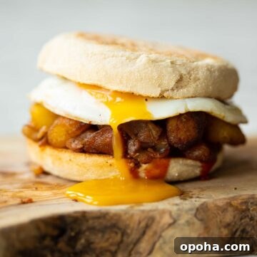 close up shot of potato sandwich on chopping board with yolk dripping out
