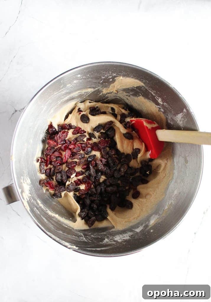 gluten-free hot cross buns batter with cranberries in a steel bowl