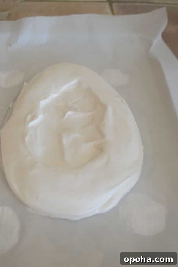 Easter Pavlova Recipe with Fresh Fruit Topping 5 A close up of a piece of cake on a plate, with Pavlova mixture