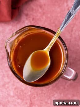 spoon in a small pitcher of salted caramel