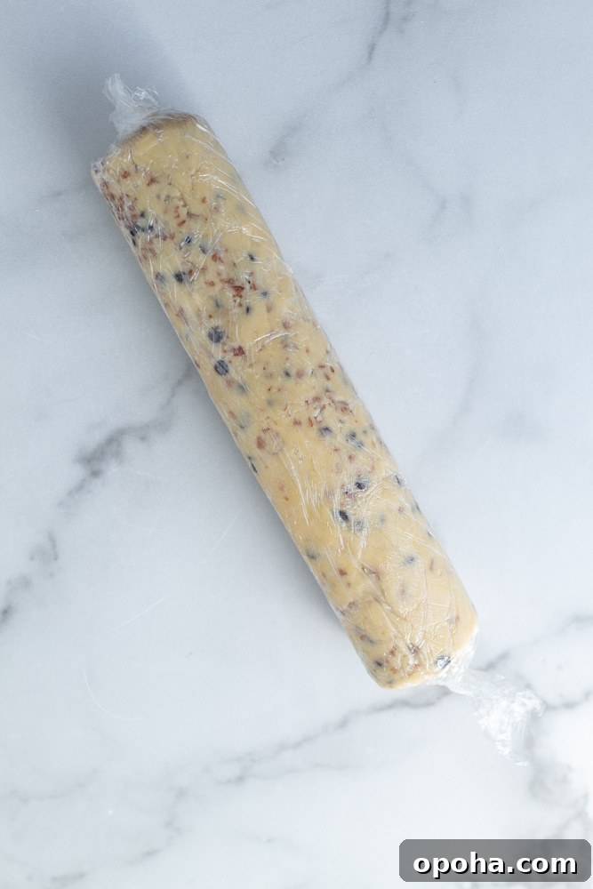 A log of shortbread cookie dough wrapped in plastic wrap.