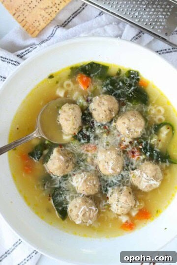 italian wedding soup in a bowl with spoon