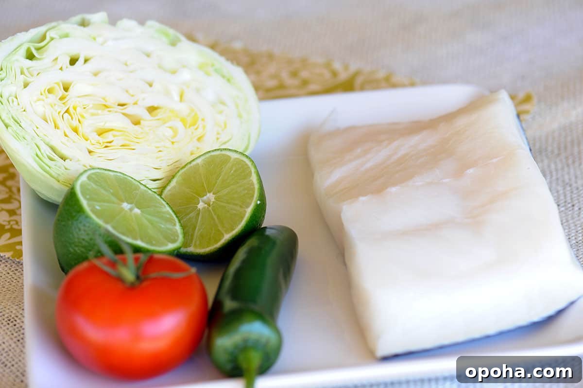 Grilled Chilean Sea Bass Tacos with Lime and Cilantro 3 plate of cabbage, tomato, jalapeno, lime and sea bass.