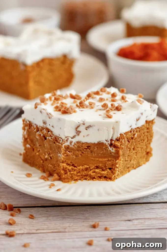 Gluten-Free Pumpkin Bars with Dairy-Free Option - Moist Fall Treat 2 Orange pumpkin bars topped with bright white toffee bit cream cheese frosting.