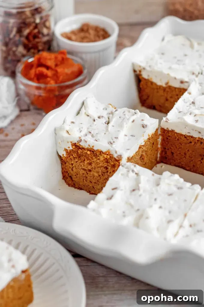 Gluten-Free Pumpkin Bars with Dairy-Free Option - Moist Fall Treat 5 Orange pumpkin bars topped with bright white toffee bit cream cheese frosting.