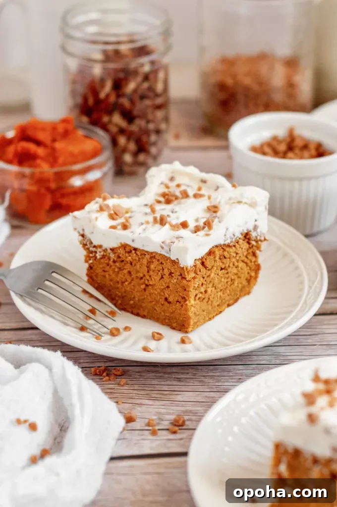 Gluten-Free Pumpkin Bars with Dairy-Free Option - Moist Fall Treat 6 Orange pumpkin bars topped with bright white toffee bit cream cheese frosting.