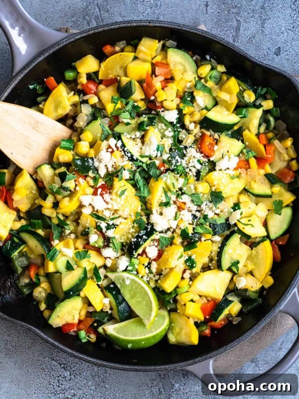Calabacitas served in a cast iron skillet and photographed from overhead.
