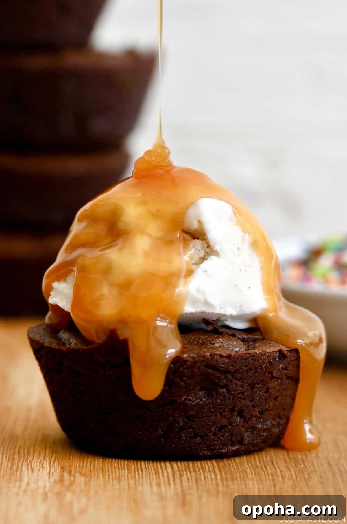 Fudgy From-Scratch Brownie Cupcakes Recipe 6 A fudge brownie cupcake topped with vanilla ice cream and a drizzle of caramel sauce.