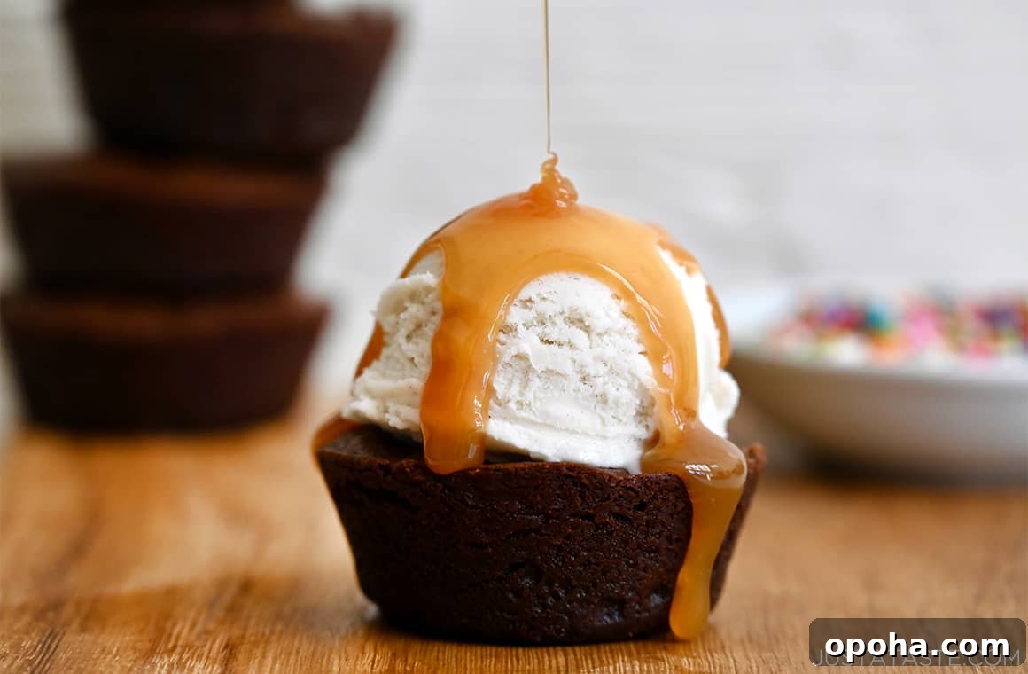 Fudgy From-Scratch Brownie Cupcakes Recipe 7 A chocolate cupcake brownie topped with vanilla ice cream drizzled with caramel sauce.
