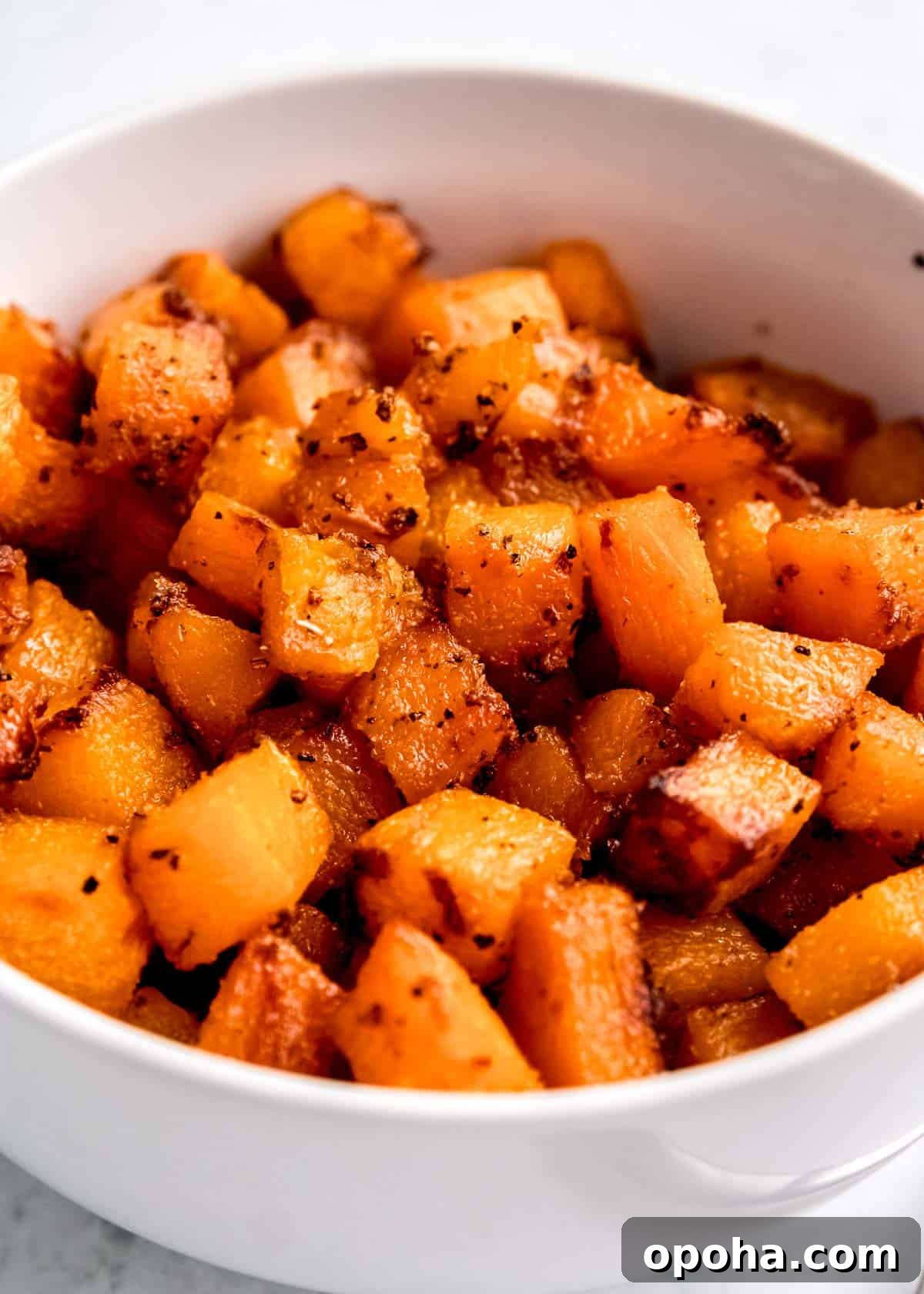 cubed air fryer butternut squash in white bowl