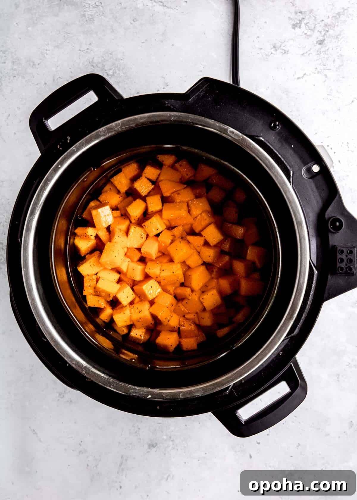 raw cubed butternut squash in an air fryer
