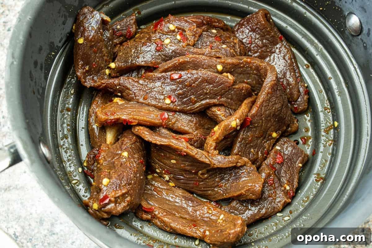 Sesame-Glazed Venison Jerky Recipe: Savory Sweet Game Meat Snack 6 Venison jerky strained in colander