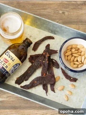 Deer jerky on tray with beer and nuts