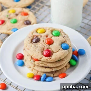M&M Cookie recipe stacked on top of each other on white plate.