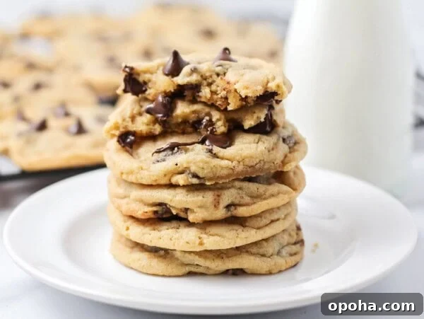Best chocolate chip cookie recipe stacked on white plate.