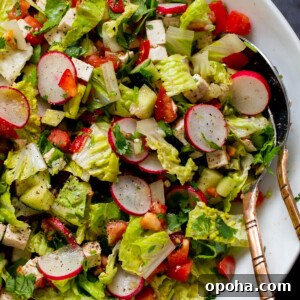 close-up of chaat masala salad in the mixing bowl with serving spoons