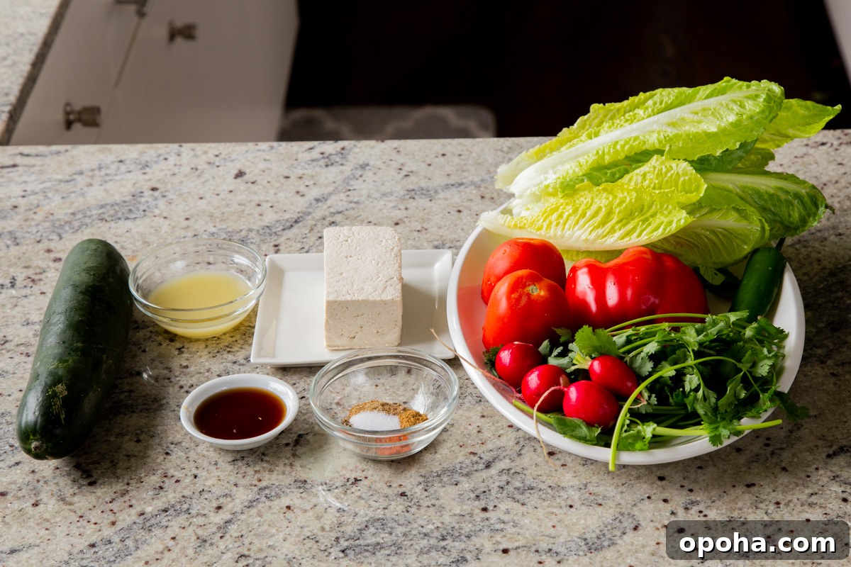 tofu, veggies, and chaat masala dressing ingredients in bowls on a kitchen counter