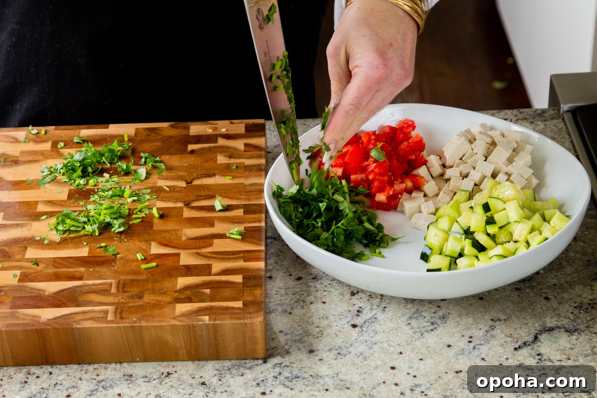 adding cilantro to the salad bowl