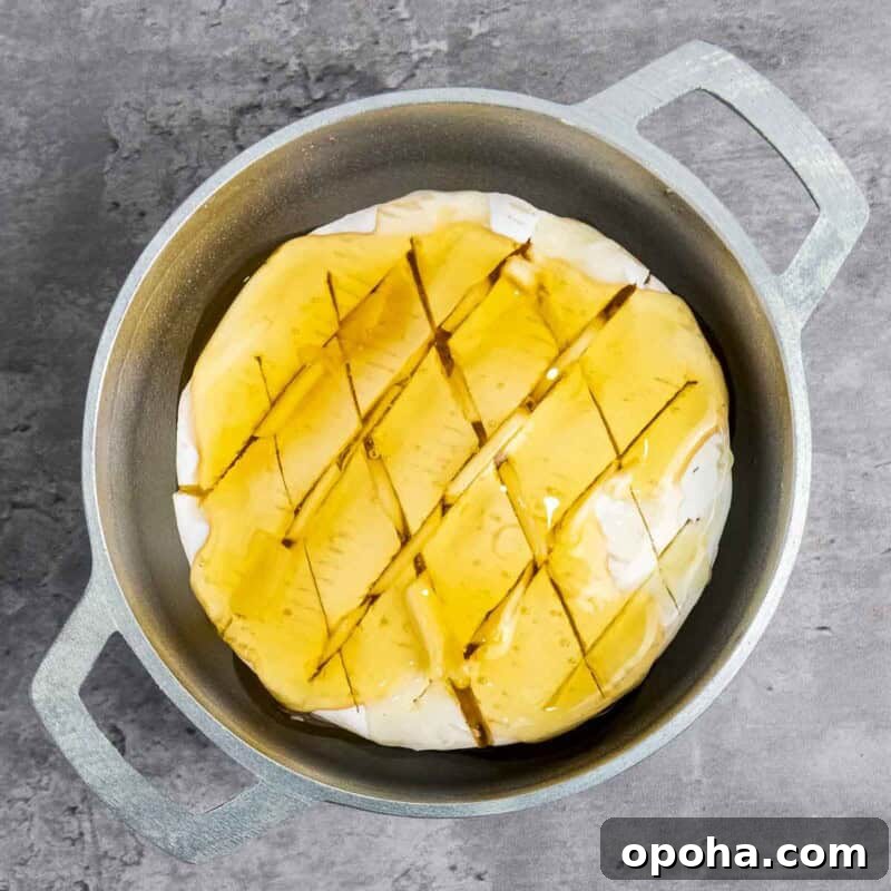 Process shot 2 - drizzle the honey and olive oil over the top of the brie.