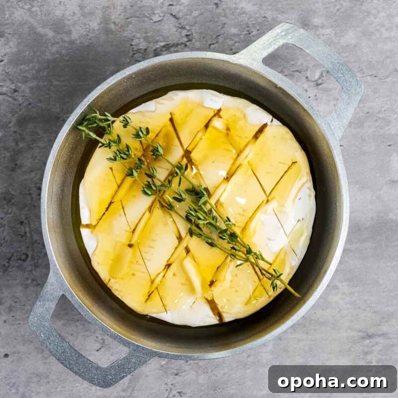 Process shot 3 - place thyme sprigs on the brie and bake until soft and gooey.