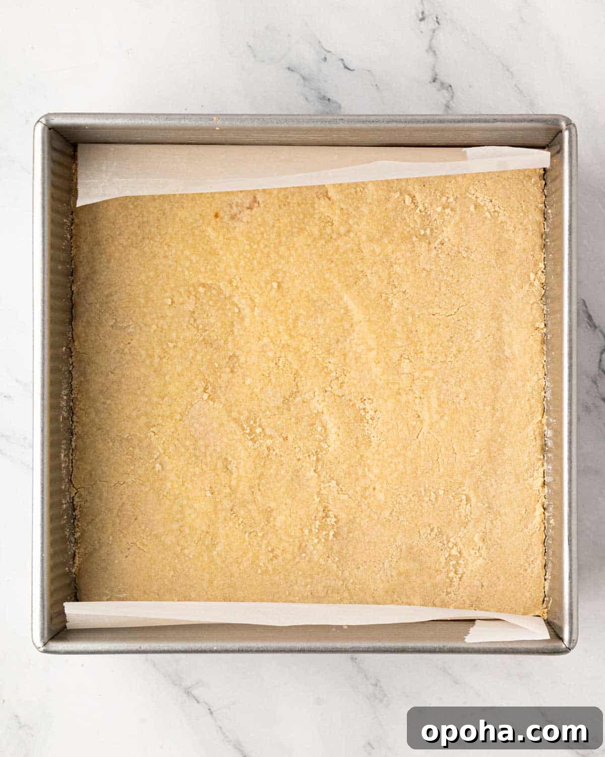 Cherry Pie Bars Recipe: Easy Homemade Cherry Dessert Bars 12 A baking pan with shortbread cookie pressed in the bottom and lined with parchment.