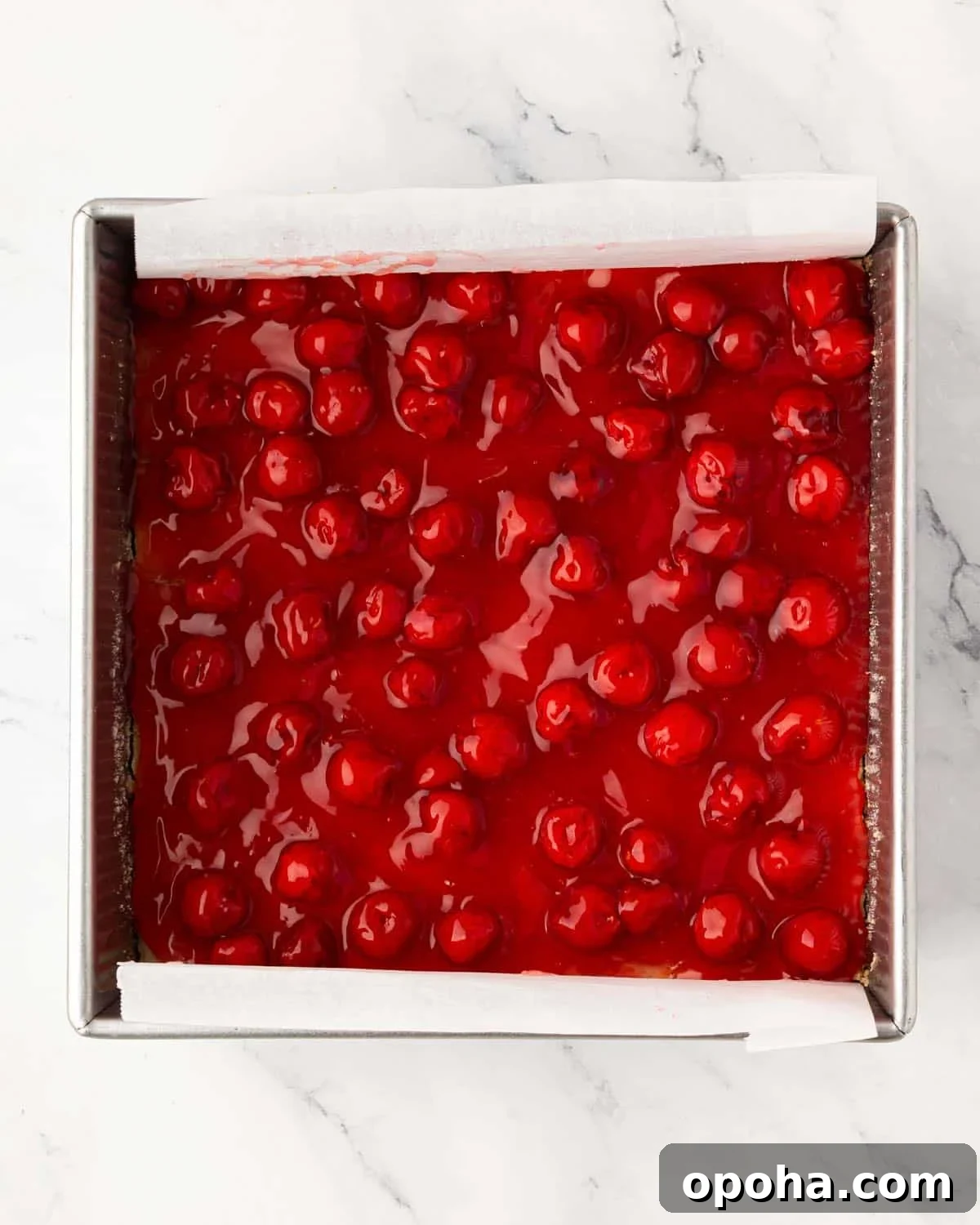 Cherry Pie Bars Recipe: Easy Homemade Cherry Dessert Bars 15 A baking pan with cherry pie bars with cookie crust and cherry pie topping.