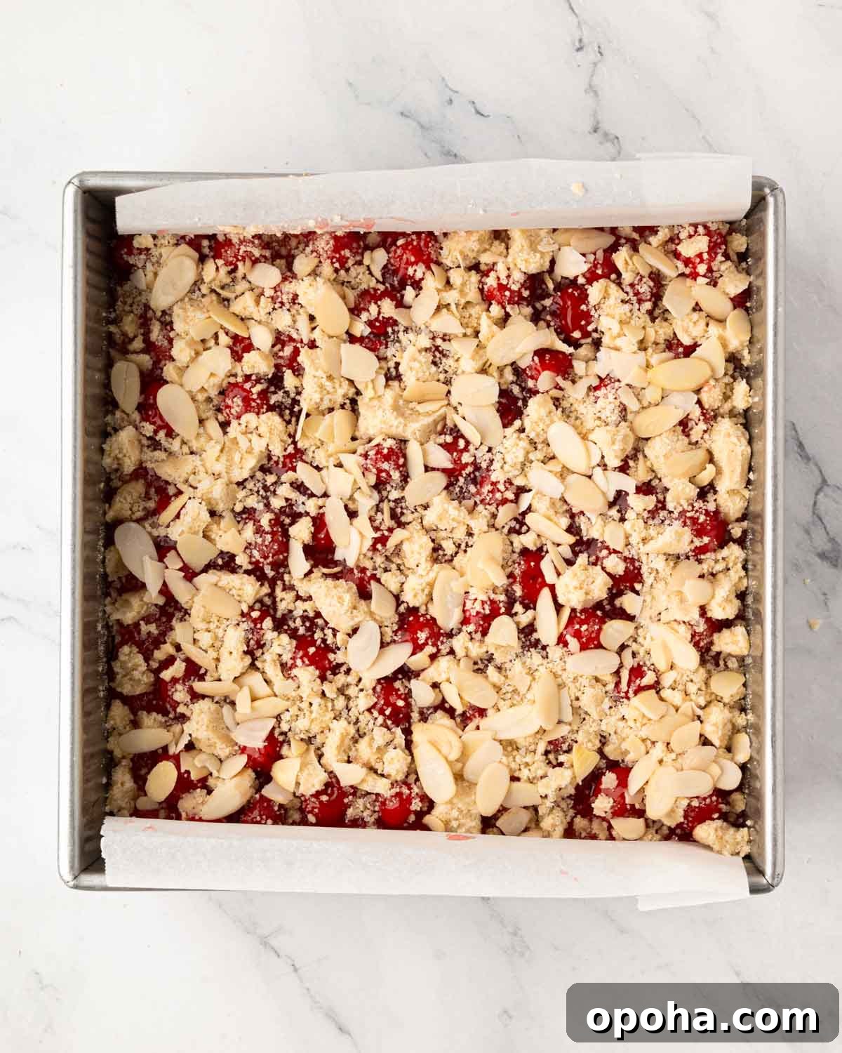 Cherry Pie Bars Recipe: Easy Homemade Cherry Dessert Bars 16 A baking pan with cherry pie bars with streusel and almond topping.