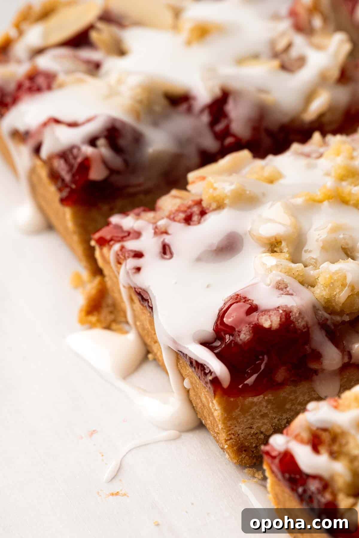 Cherry Pie Bars Recipe: Easy Homemade Cherry Dessert Bars 21 Side view of iced cherry pie bars.