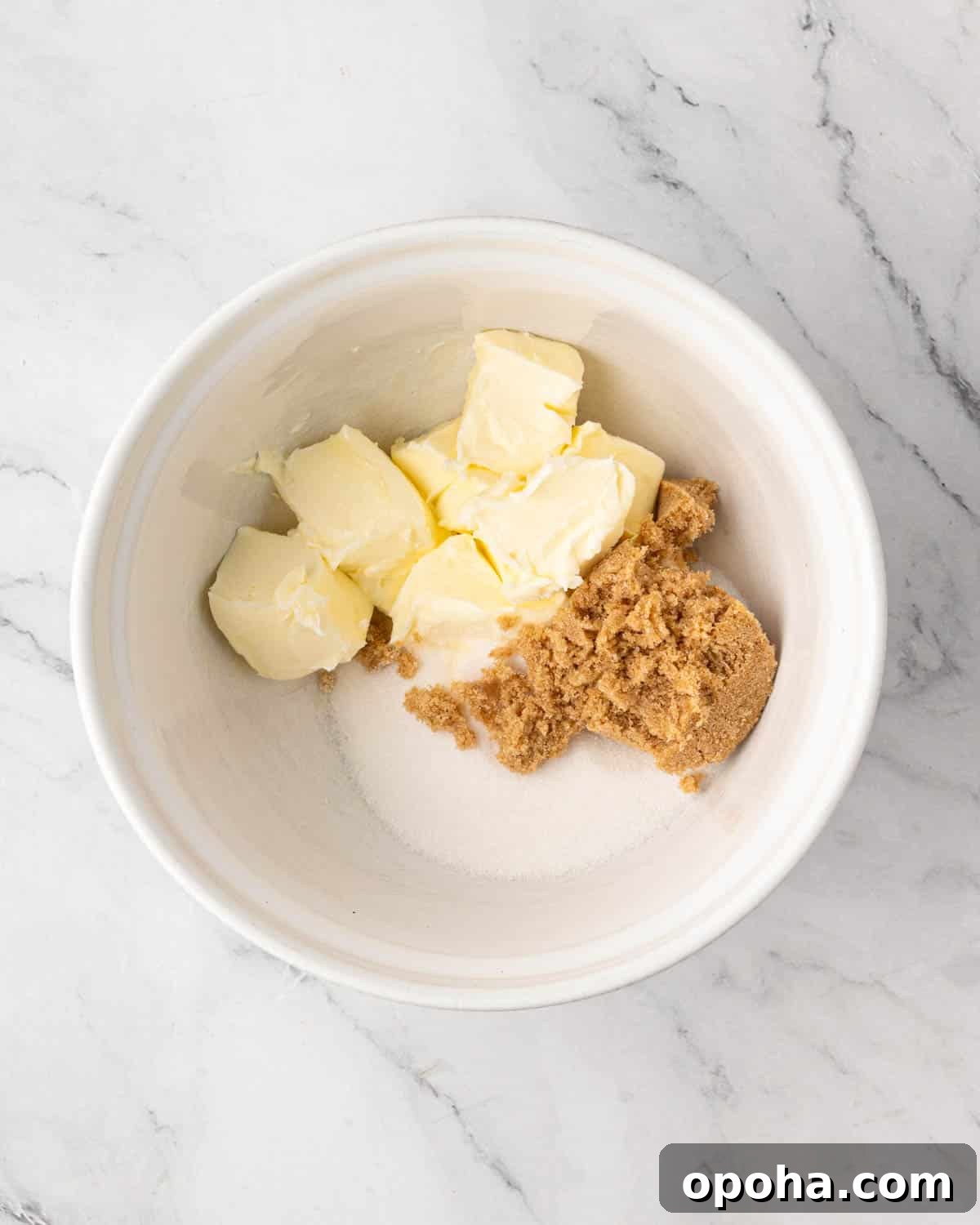 Cherry Pie Bars Recipe: Easy Homemade Cherry Dessert Bars 5 A white bowl with butter, brown sugar, and regular sugar.