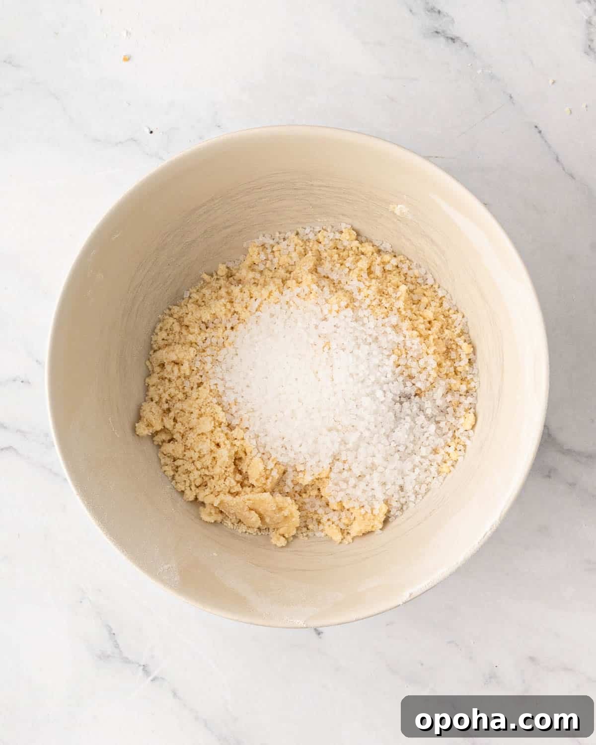 Cherry Pie Bars Recipe: Easy Homemade Cherry Dessert Bars 10 A white bowl with shortbread cookie dough and sugar on top.