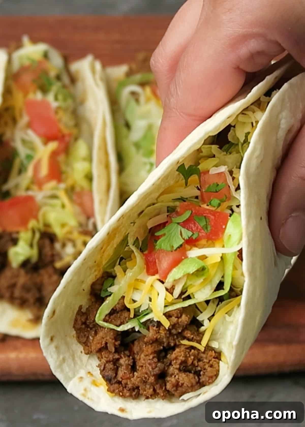 Taco Meat Recipe: Skillet, Instant Pot, or Crock Pot Options 7 close up of a ground beef taco being held