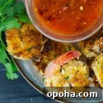 Coconut Shrimp on plate with bowl of peach chili sauce