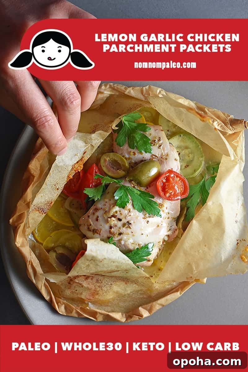 An overhead shot of someone opening into a lemon garlic chicken parchment packet, a Whole30, keto, and paleo easy weeknight dinner.