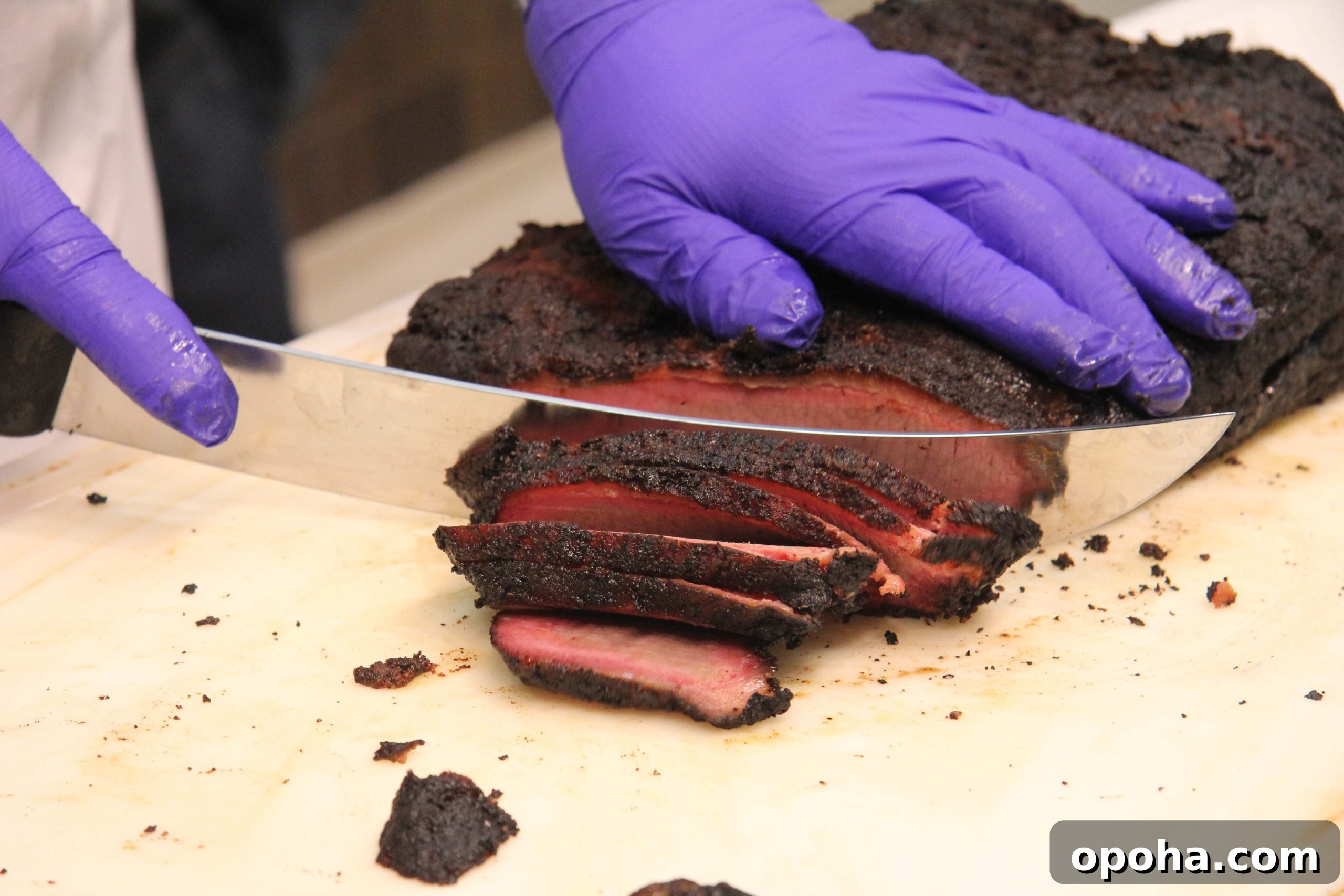 Dr Savell uses a scimitar-style knife to slice the cooked brisket