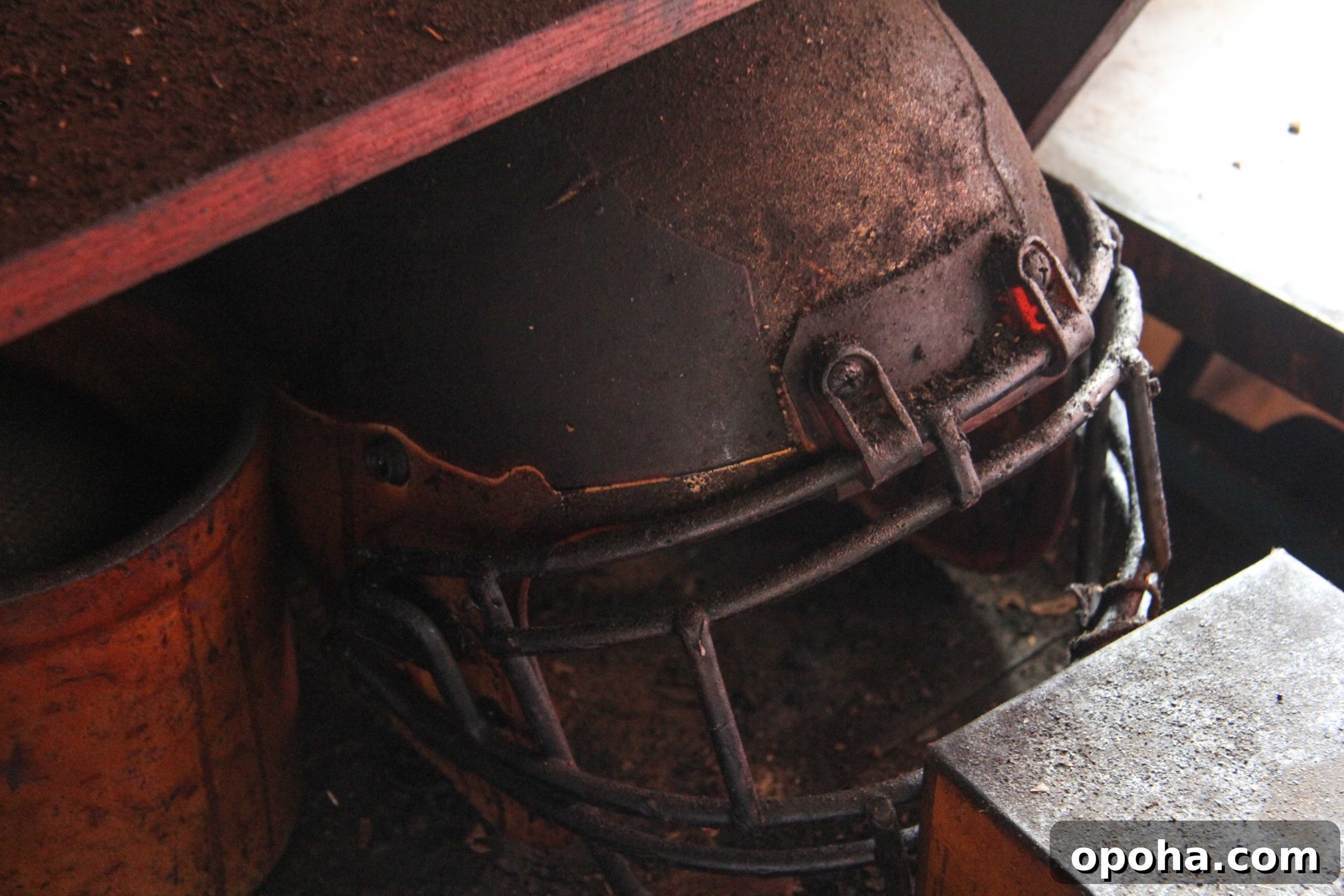 An old football helmet covered in ash & soot sits untouched in the pit room at Martin's Place