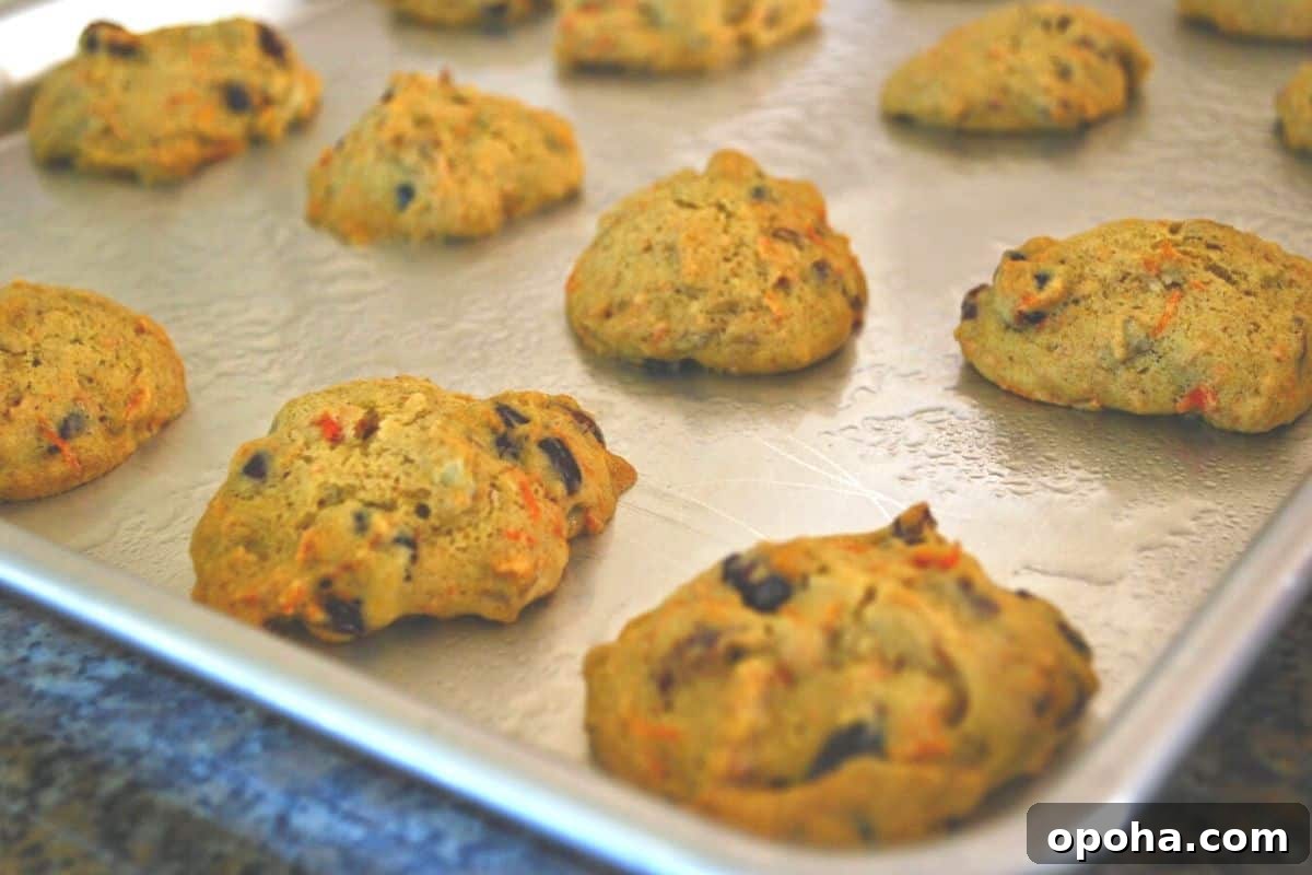 Carrot Cake Cookies Recipe — Moist Spiced Cookies with Cream Cheese Frosting 7 carrot cake cookies on cookie sheet