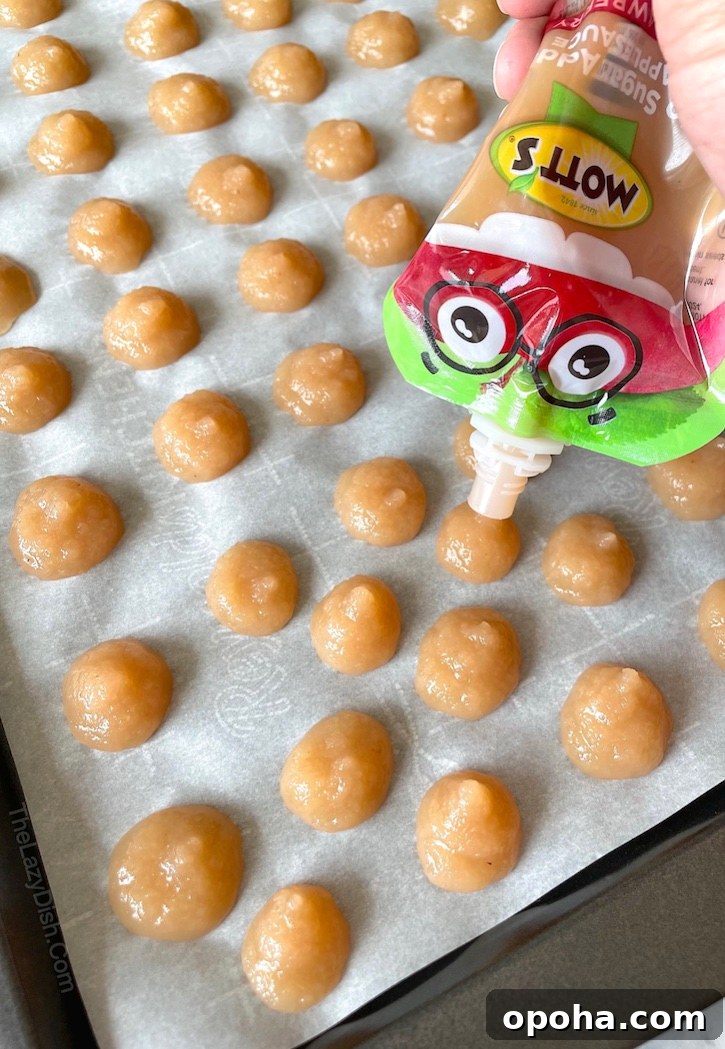 Frozen Applesauce Bites: Kid-Friendly Chilled Snack Recipe 4 Are you looking for fun and easy snack ideas for toddlers? These healthy applesauce bites are super simple to make, and kids of all ages love them! They are perfect for 2 year olds and 3 year olds. Simply freeze little dollops of applesauce to make these yummy treats.