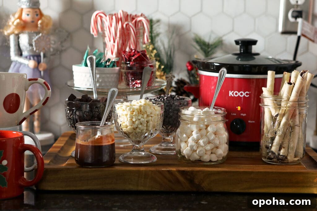 Create a DIY Hot Chocolate Bar for Parties and Gatherings 4 A hot chocolate bar on a countertop with various toppings and a small slow cooker of hot cocoa