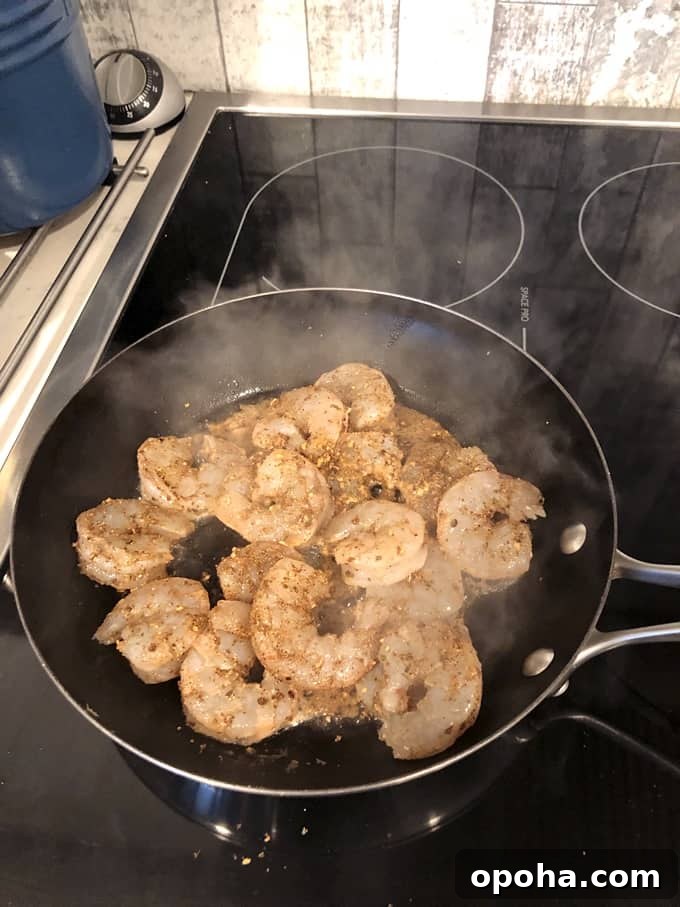 WeightWatchers-Friendly Spiced Shrimp Tacos with Lime Slaw 3 Sautéing spiced shrimp in pan on stove