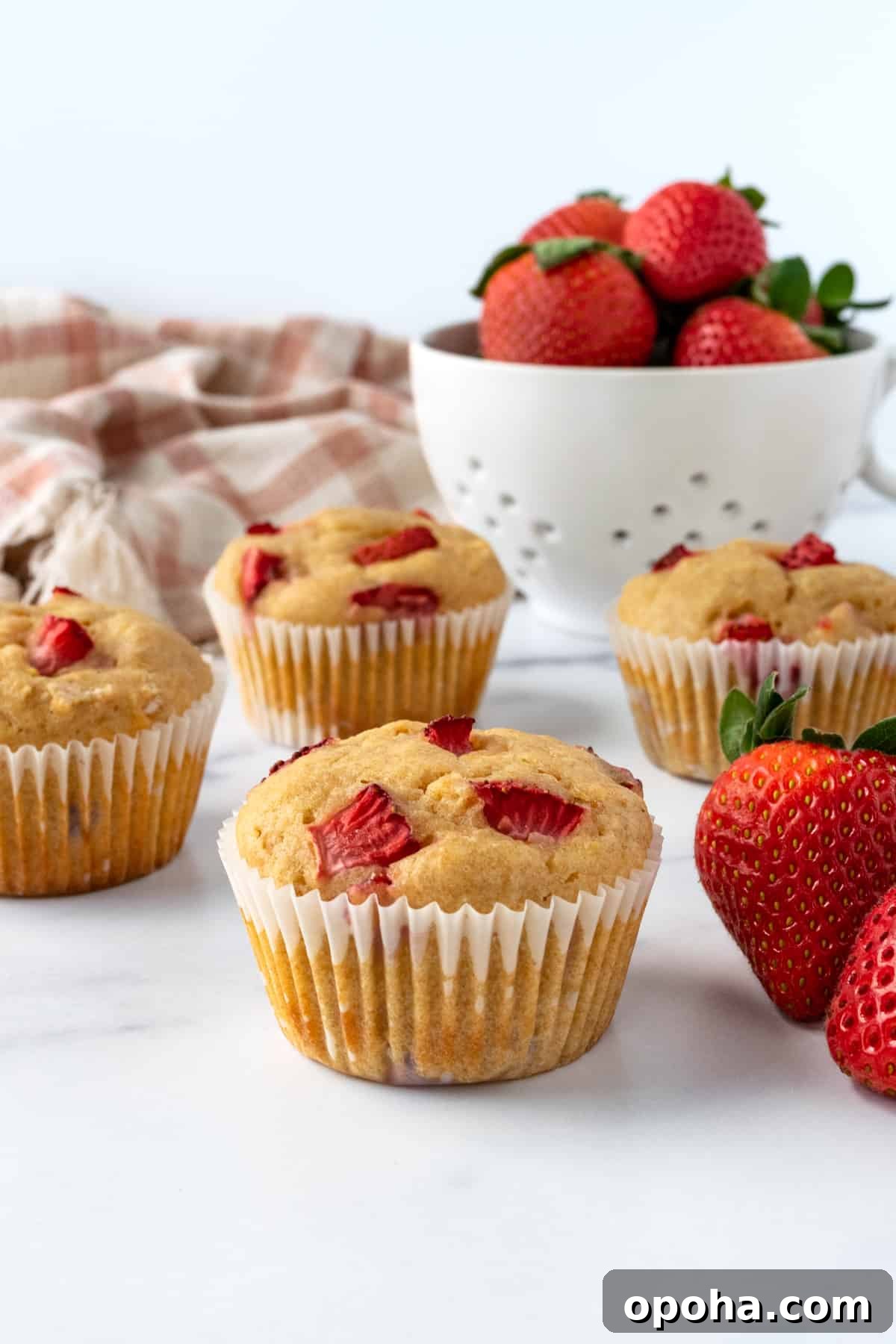 Strawberry Lemon Muffins on a white table.