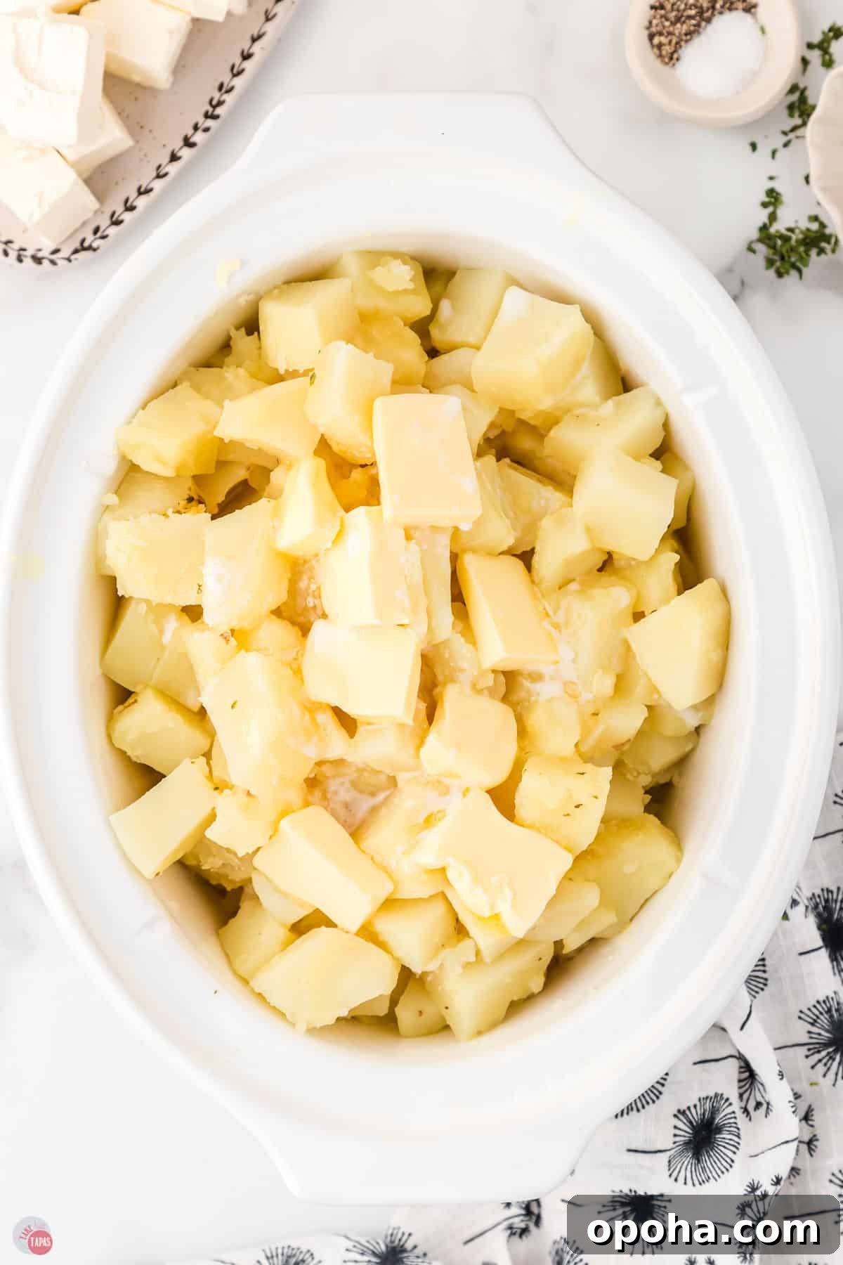 Decadent Million Dollar Mashed Potatoes Recipe 5 boiled potatoes in a white crock pot