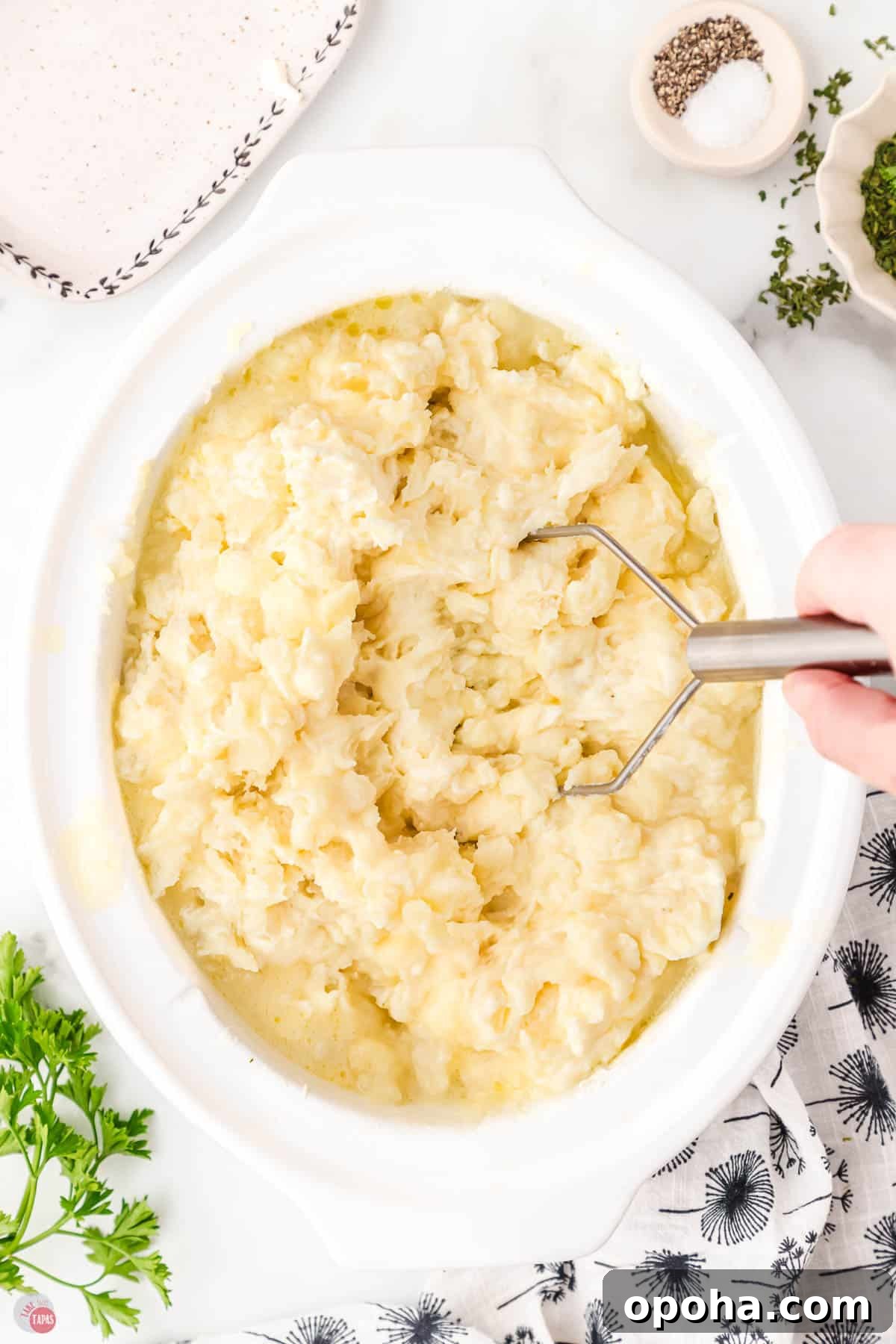 Decadent Million Dollar Mashed Potatoes Recipe 7 hand mashed boiled potatoes in a white crock pot