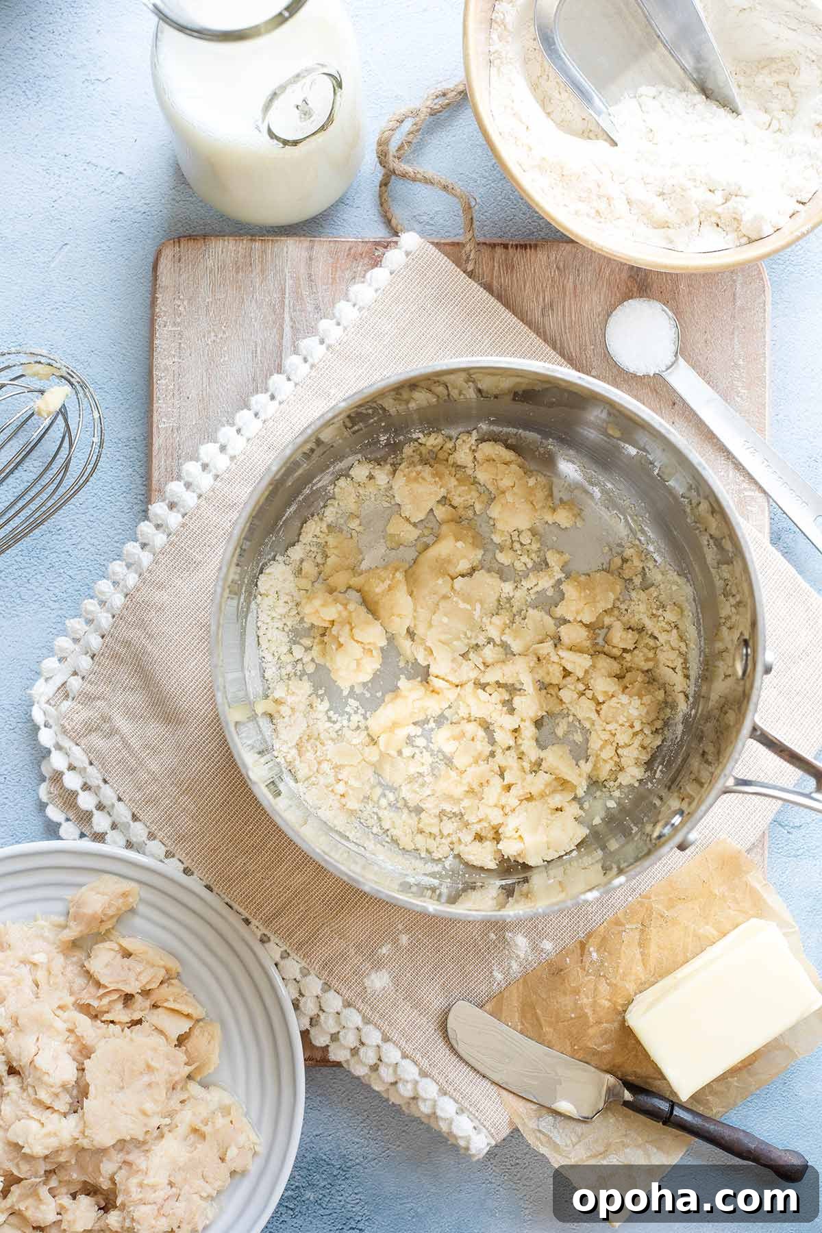 Pan with flour clumping together just after being added to melted butter.