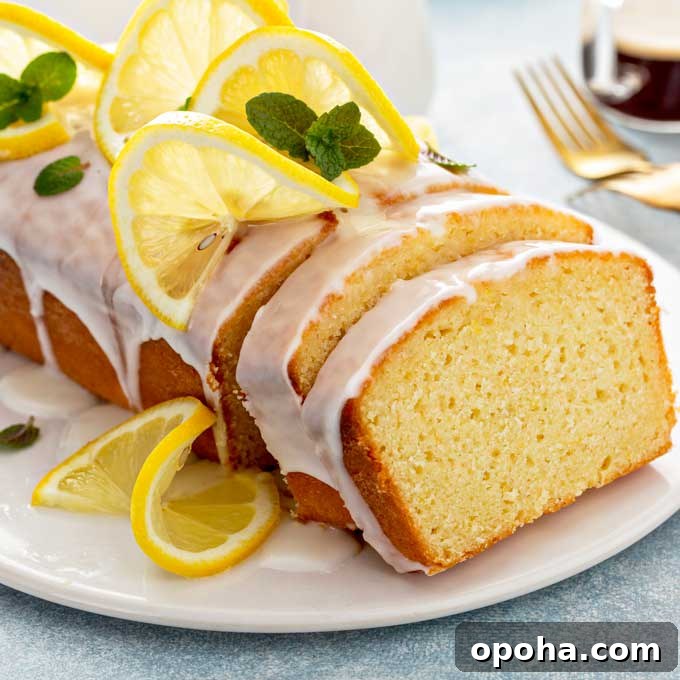 14 Delicious Easter Recipes to Make at Home 12 Lemon loaf drizzled with lemon glaze on a white plate