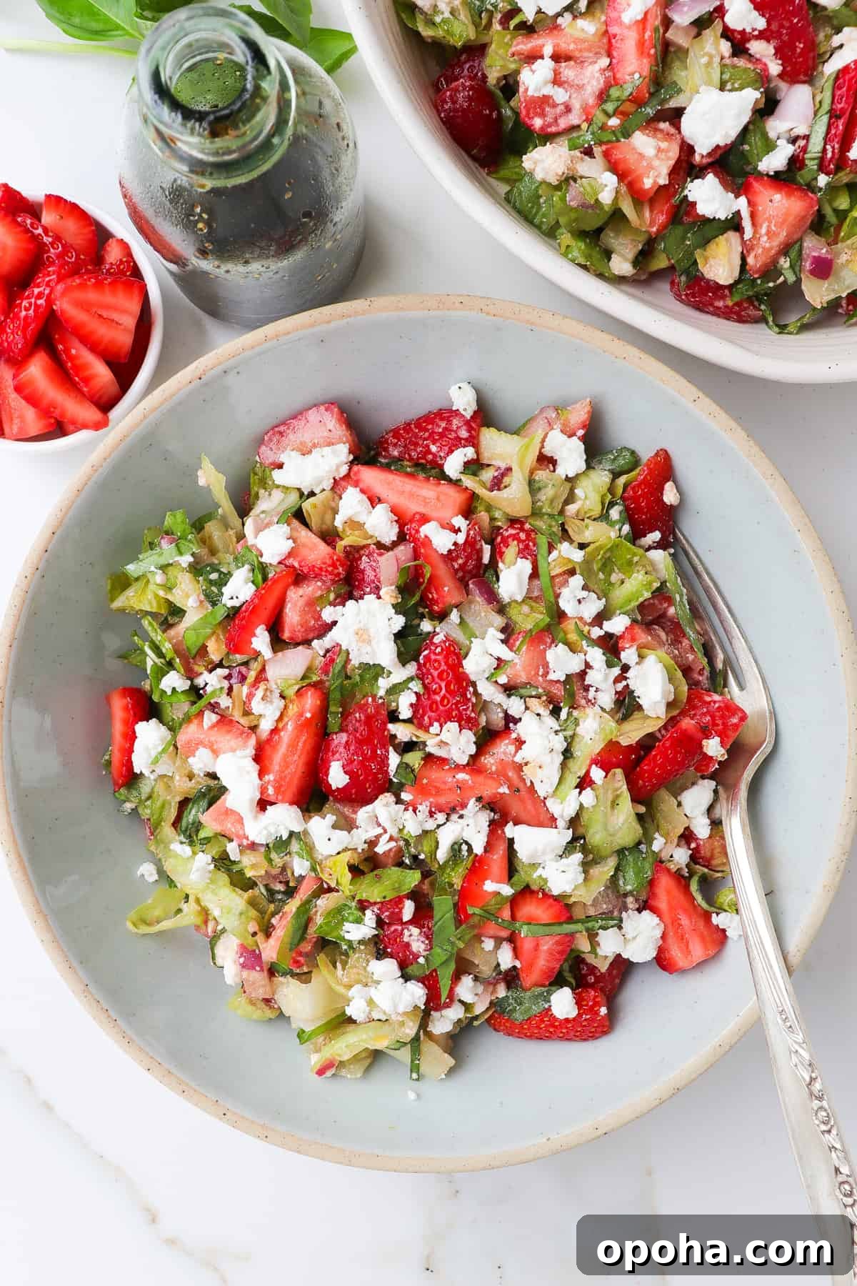 Strawberry and Goat Cheese Salad with Balsamic Glaze 2 Strawberry goat cheese salad in a blue bowl with a fork.