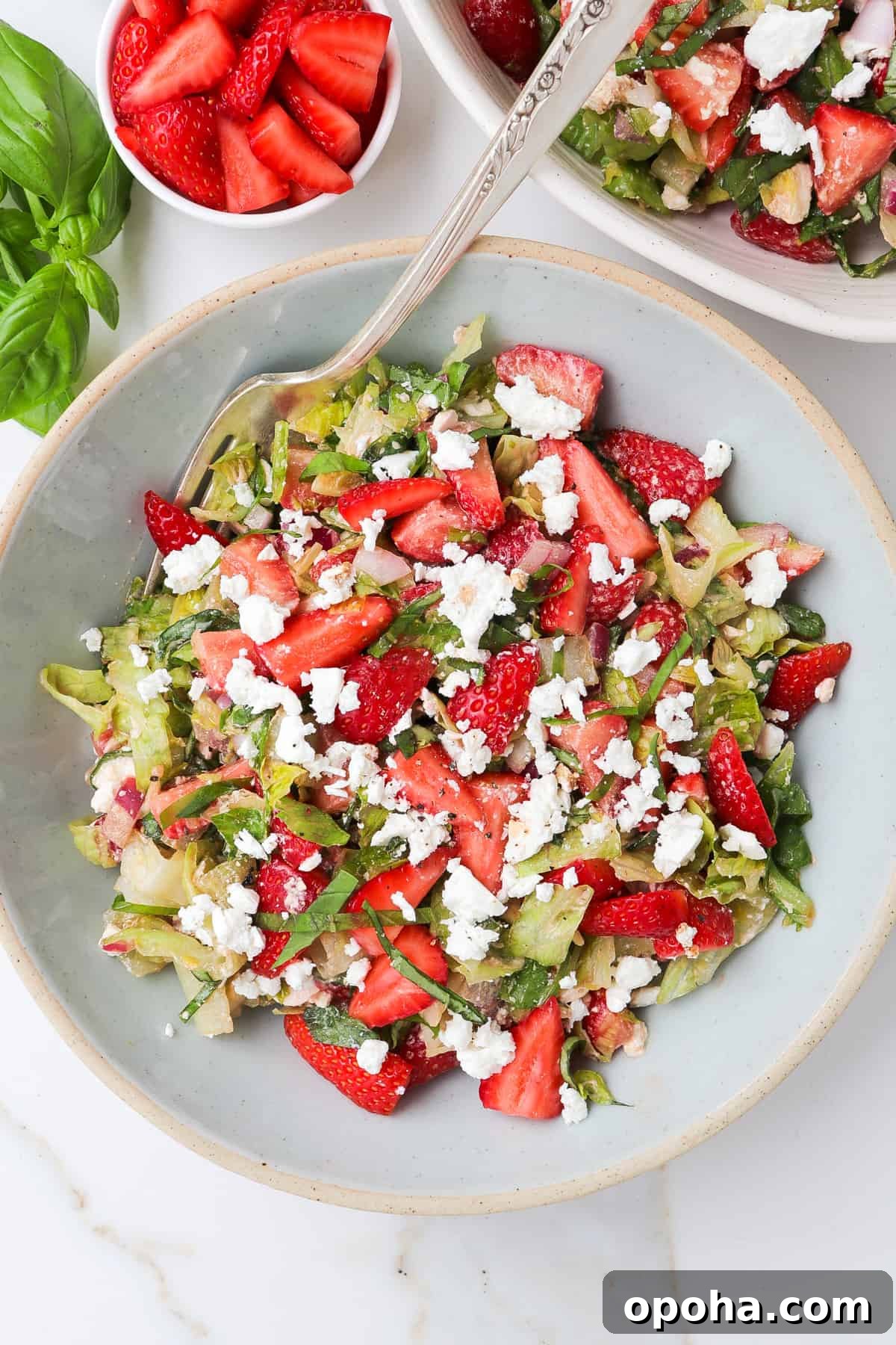 Strawberry and Goat Cheese Salad with Balsamic Glaze 3 Strawberry salad in a blue bowl with a fork at the top