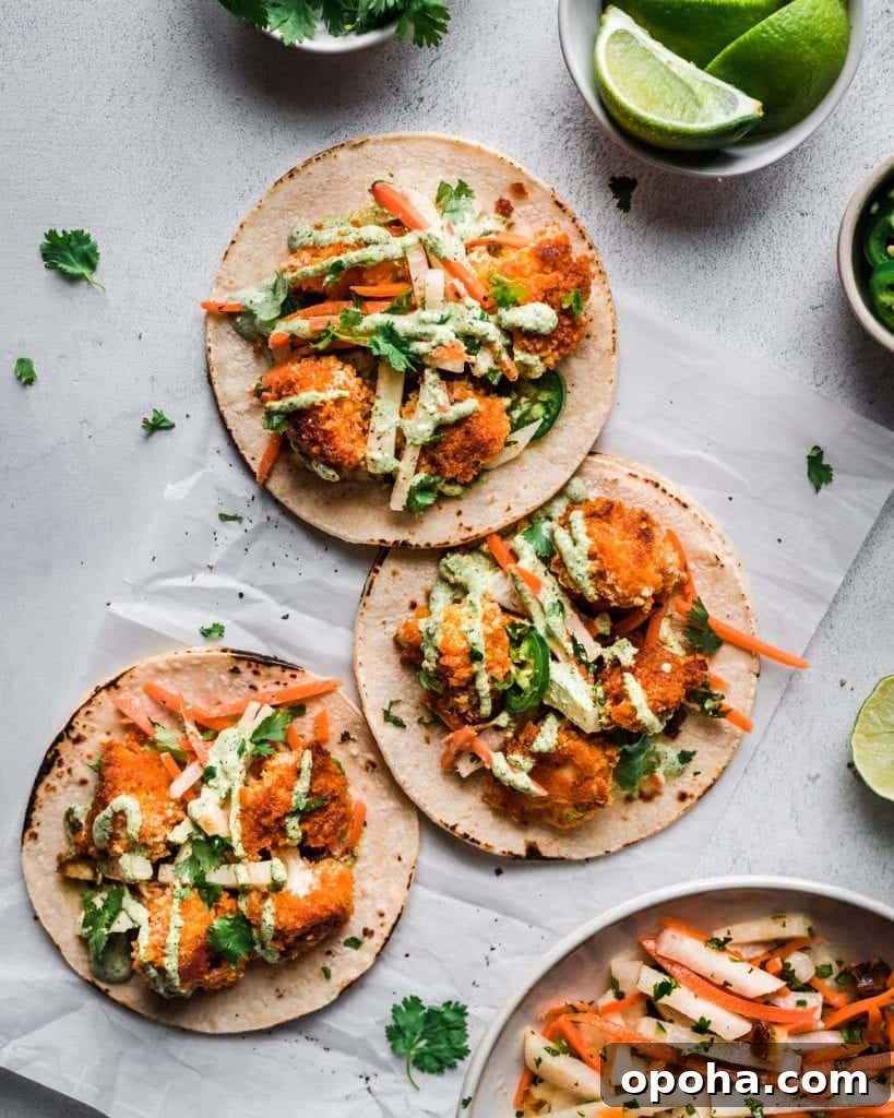 three tacos with baked crispy cauliflower on parchment paper