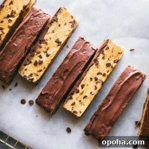 chocolate chip cookie dough bars arranged in a line on parchment paper