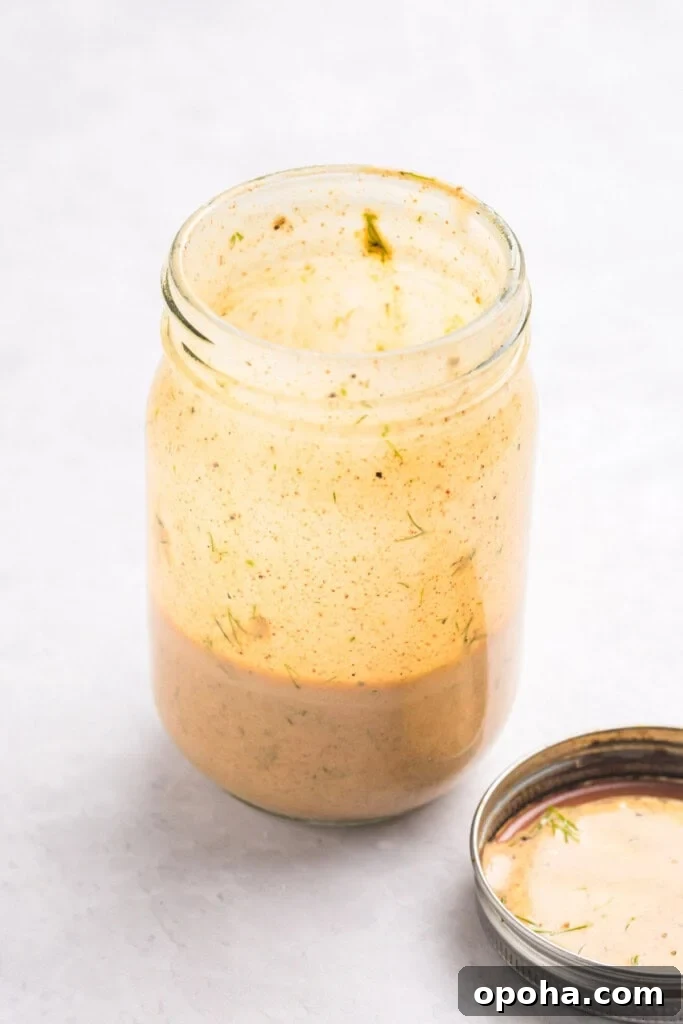 Mediterranean Tuna and Chickpea Salad dressing ingredients in a mason jar