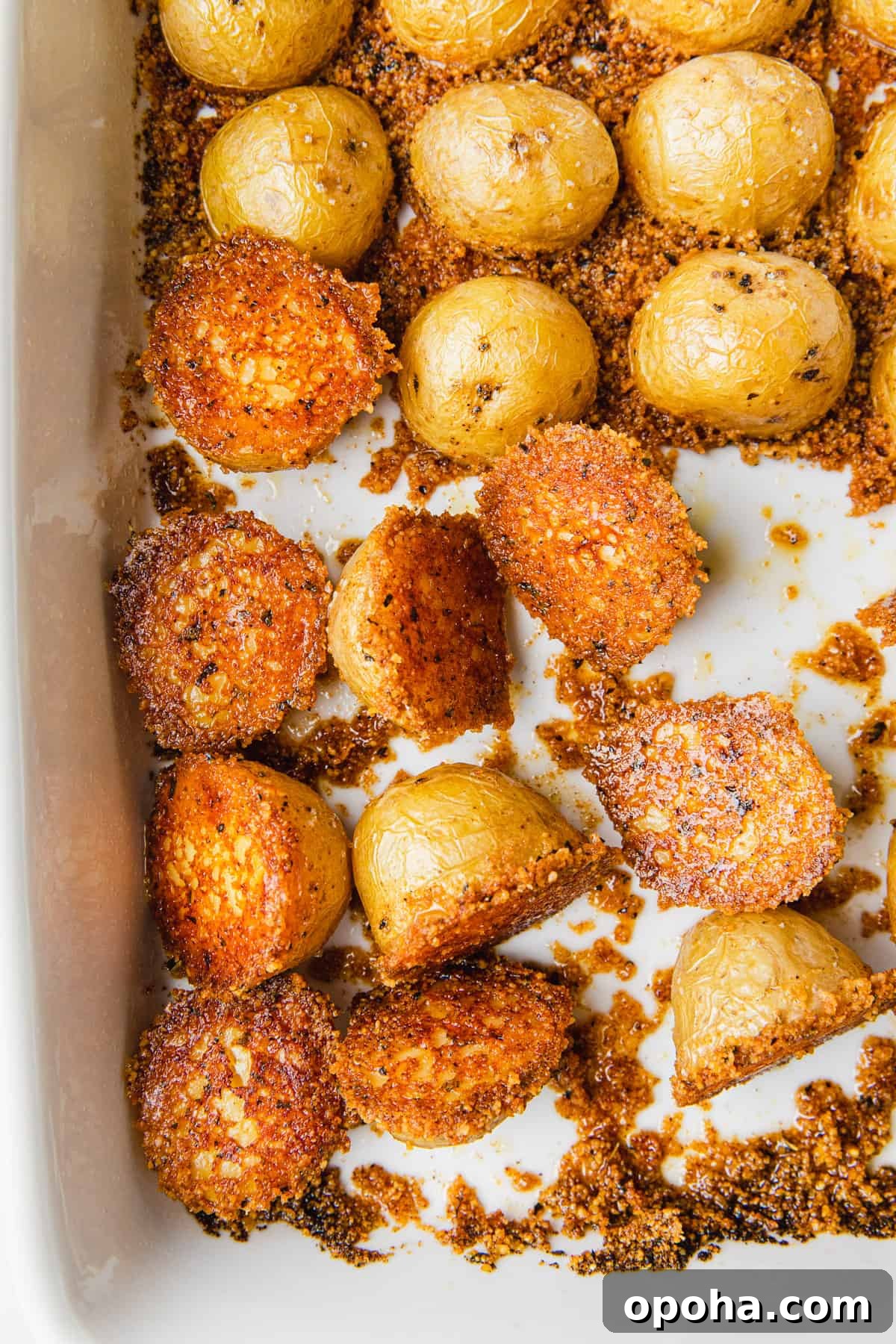 Cooked potatoes flipped over in a baking dish.